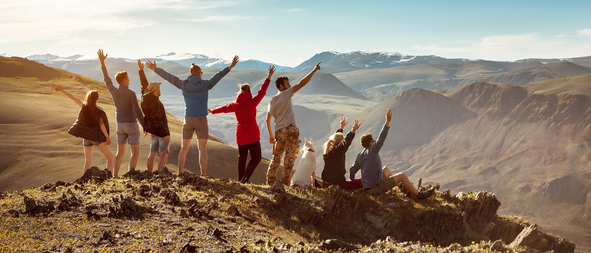 Big group happy friends in mountains